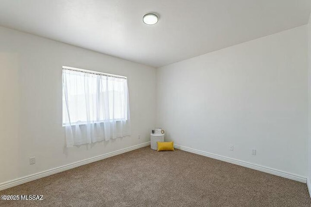 empty room with carpet and baseboards