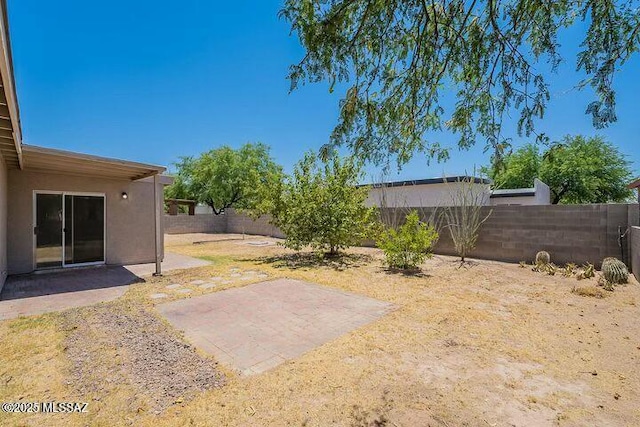 view of yard with a patio and a fenced backyard