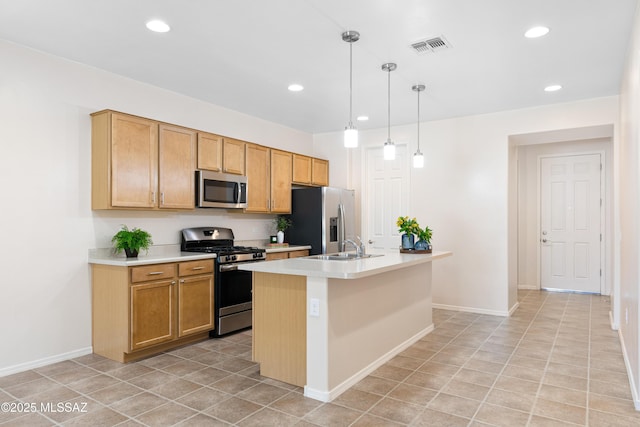 kitchen featuring a center island with sink, appliances with stainless steel finishes, light countertops, pendant lighting, and recessed lighting
