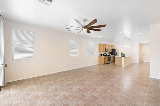unfurnished living room featuring recessed lighting, visible vents, baseboards, a ceiling fan, and a wealth of natural light