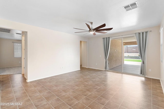 unfurnished room featuring visible vents, ceiling fan, and baseboards