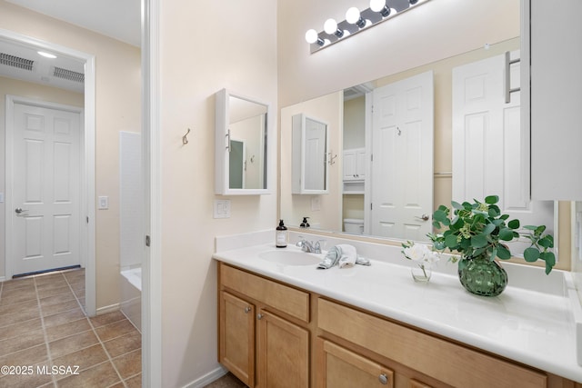 bathroom with toilet, tile patterned floors, visible vents, and vanity