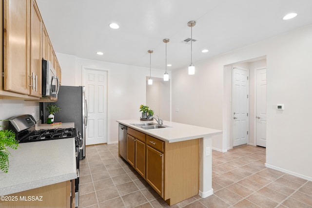 kitchen featuring a sink, a center island with sink, stainless steel appliances, and light countertops