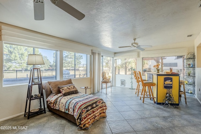 sunroom with visible vents and ceiling fan