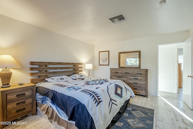 bedroom featuring visible vents and light wood-style flooring