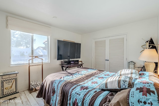 bedroom featuring a closet and wood finished floors