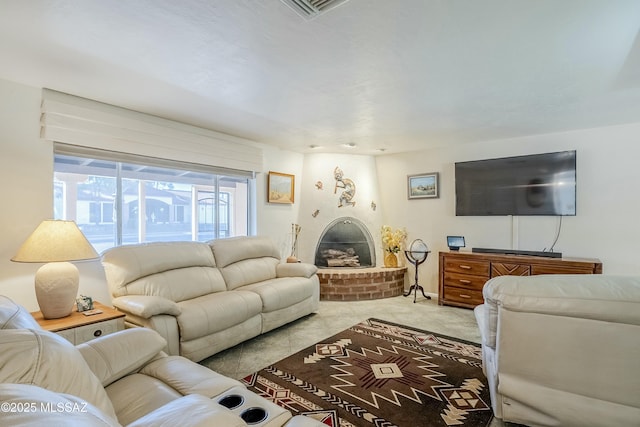 carpeted living area with a brick fireplace and visible vents