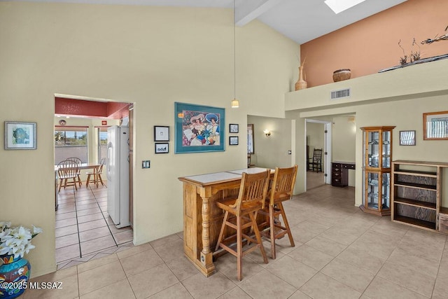 dining room featuring high vaulted ceiling, light tile patterned floors, visible vents, and beamed ceiling