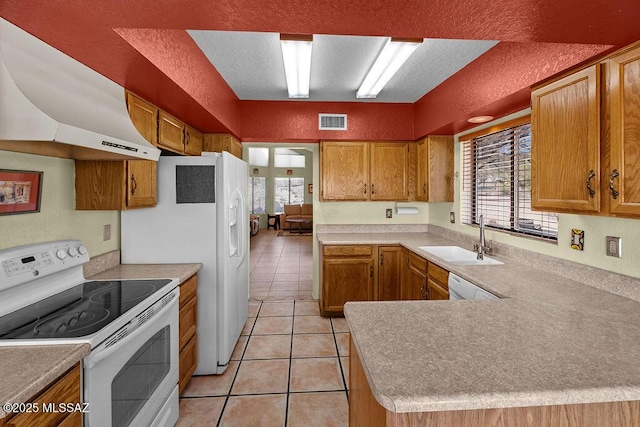 kitchen featuring light tile patterned floors, under cabinet range hood, white appliances, a sink, and visible vents