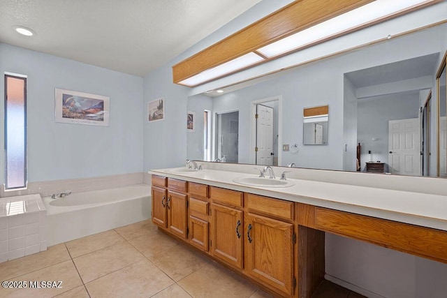 full bath with tile patterned flooring, double vanity, a sink, and a bath