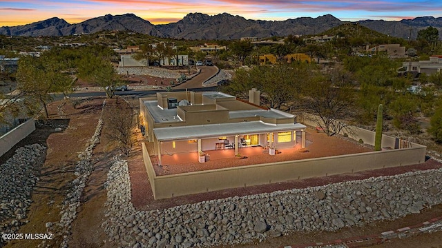 aerial view at dusk featuring a mountain view