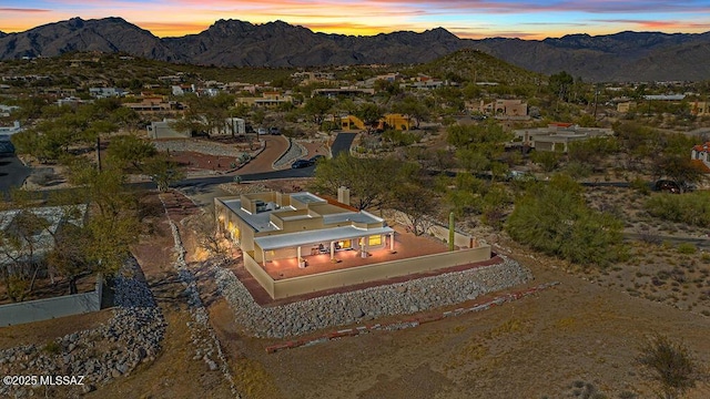 aerial view at dusk featuring a mountain view