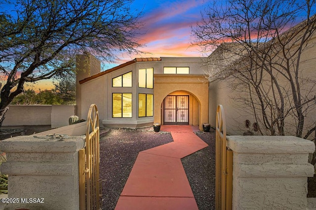 view of front of property with a chimney and stucco siding