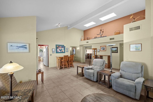 living area with high vaulted ceiling, visible vents, beamed ceiling, and light tile patterned floors