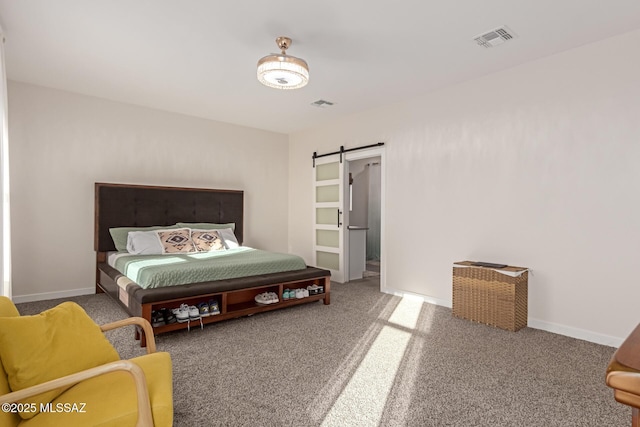 carpeted bedroom featuring a barn door, visible vents, and baseboards