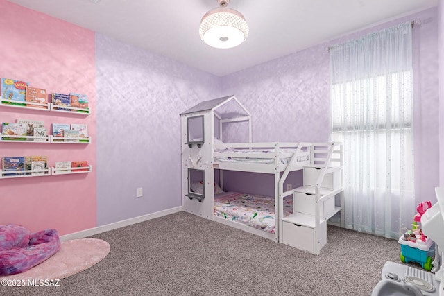 carpeted bedroom featuring baseboards