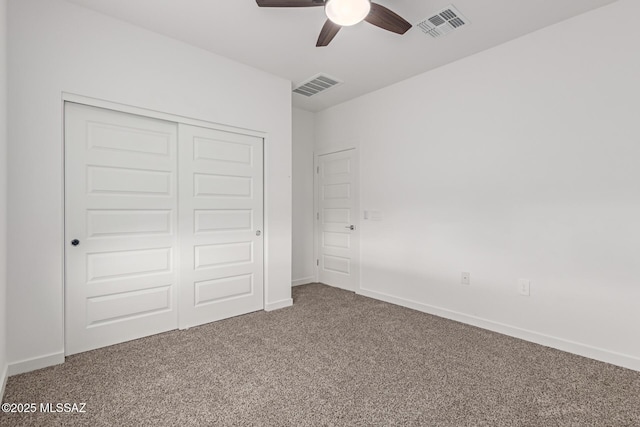 unfurnished bedroom featuring a closet, visible vents, baseboards, and carpet flooring