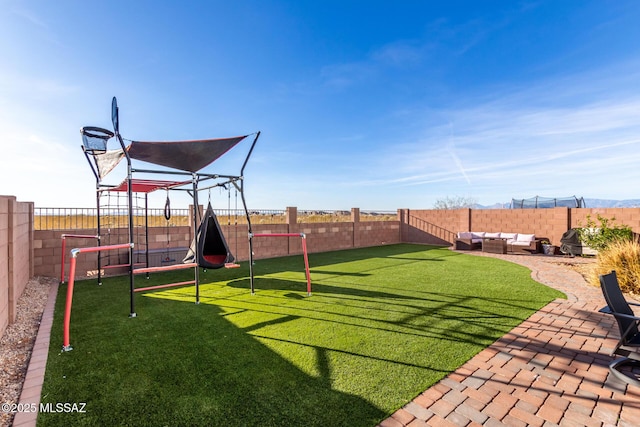 view of yard featuring a patio, a playground, a fenced backyard, and an outdoor living space