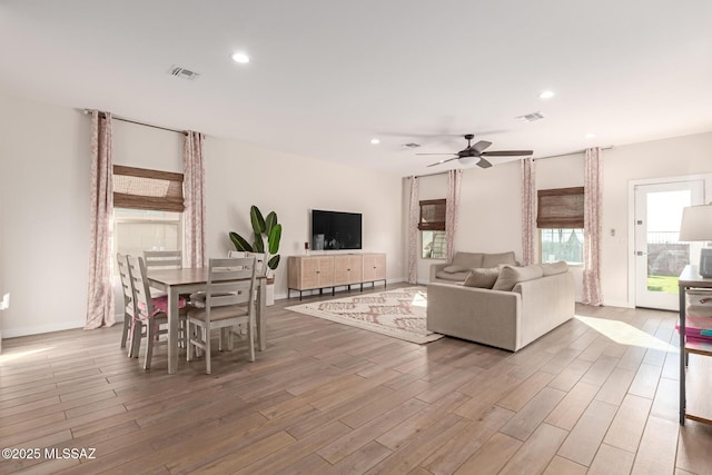 living area featuring visible vents, wood finished floors, and recessed lighting