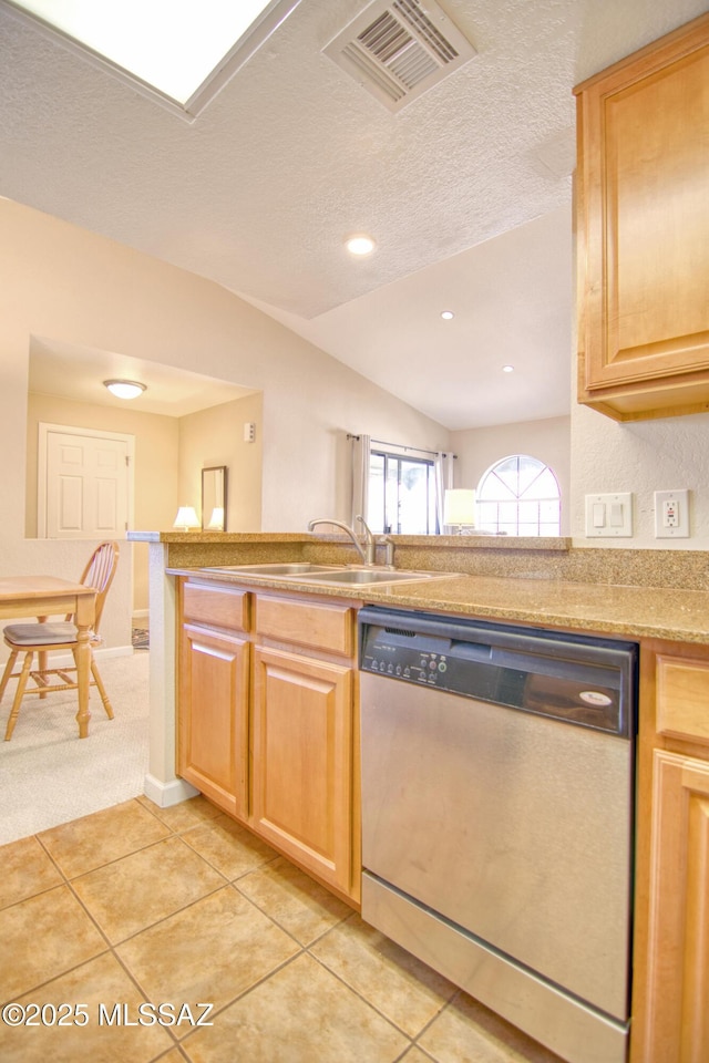 kitchen featuring light tile patterned flooring, light countertops, visible vents, dishwasher, and lofted ceiling