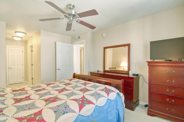 bedroom with carpet floors, ceiling fan, and visible vents