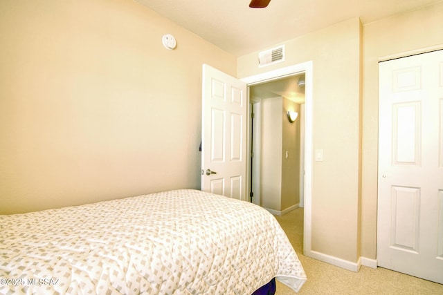 bedroom with light colored carpet, visible vents, ceiling fan, and baseboards