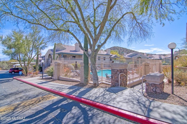 exterior space featuring a residential view and fence
