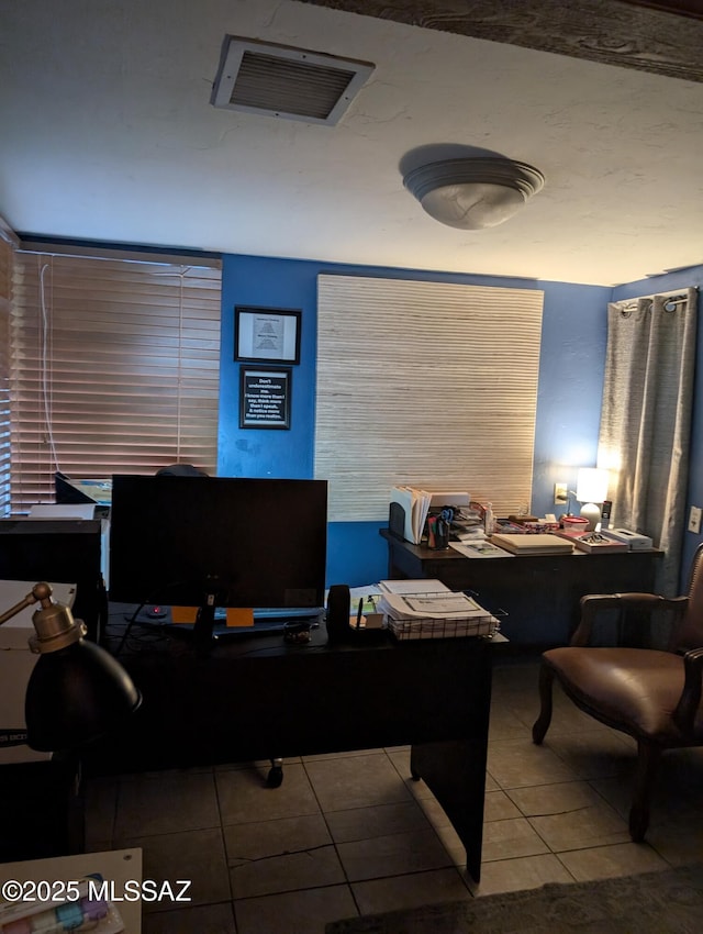 home office featuring visible vents and tile patterned floors