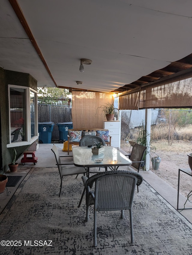 view of patio featuring fence and outdoor dining area