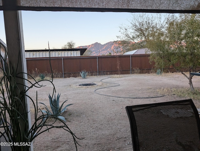 view of yard featuring a fenced backyard and a mountain view