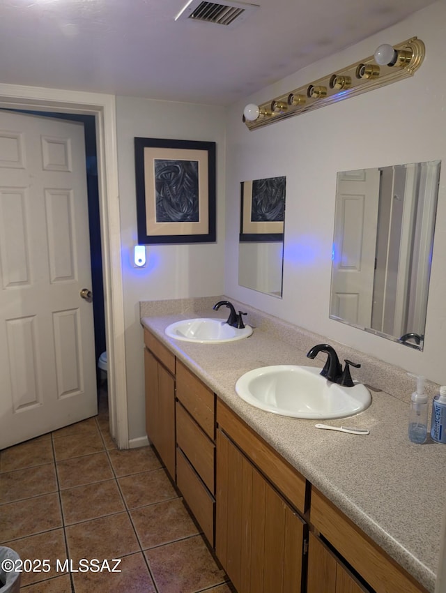 full bath with toilet, tile patterned flooring, a sink, and visible vents