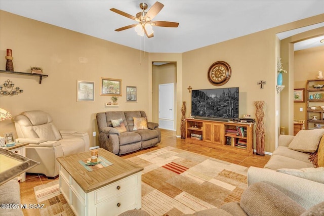 living area with ceiling fan and light tile patterned floors