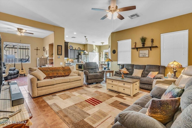 living area with light tile patterned floors, ceiling fan, visible vents, and recessed lighting