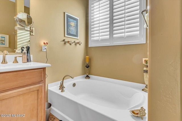 bathroom featuring a bath and vanity