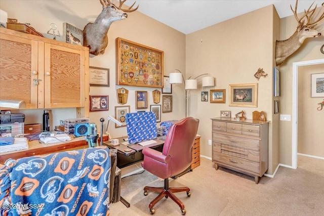 living area featuring baseboards and light colored carpet