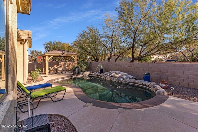 view of swimming pool featuring a fenced in pool, a fenced backyard, a patio, and a gazebo