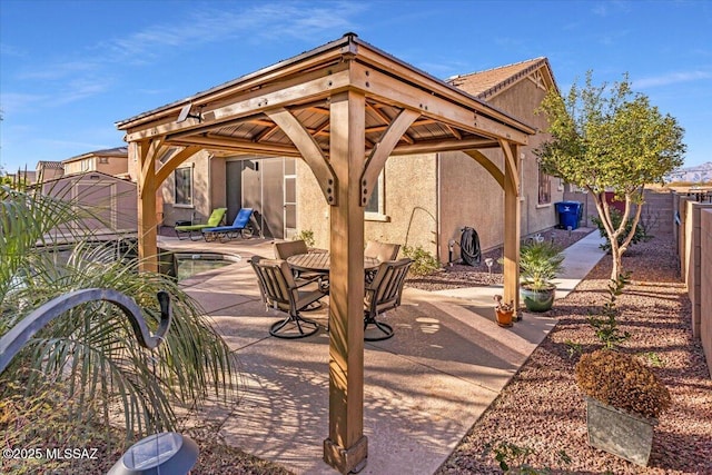 view of patio with fence and a gazebo