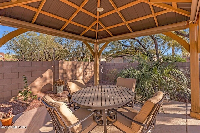 view of patio / terrace featuring outdoor dining space, a fenced backyard, and a gazebo