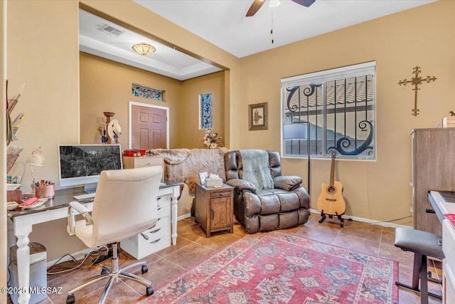 office space featuring ceiling fan, visible vents, baseboards, and light tile patterned flooring