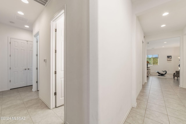 hallway featuring recessed lighting, visible vents, baseboards, and light tile patterned floors