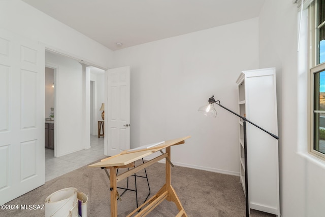 office with baseboards and light colored carpet