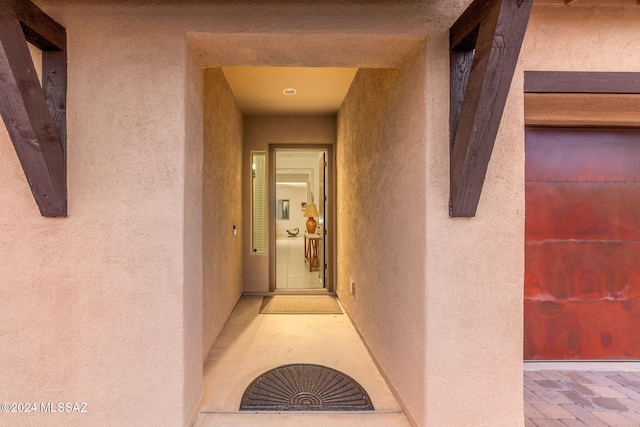 view of exterior entry with stucco siding