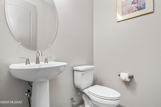 bathroom featuring a sink and toilet