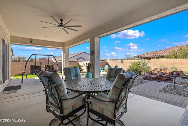 view of patio / terrace featuring a fenced backyard, outdoor dining area, and a ceiling fan