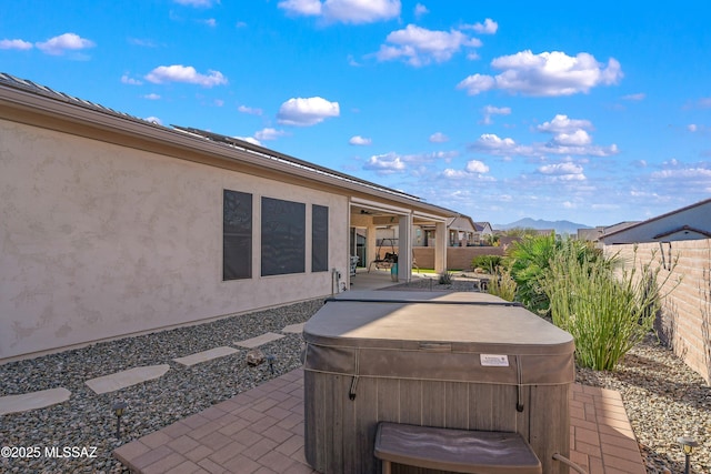 view of patio / terrace with a fenced backyard and a hot tub