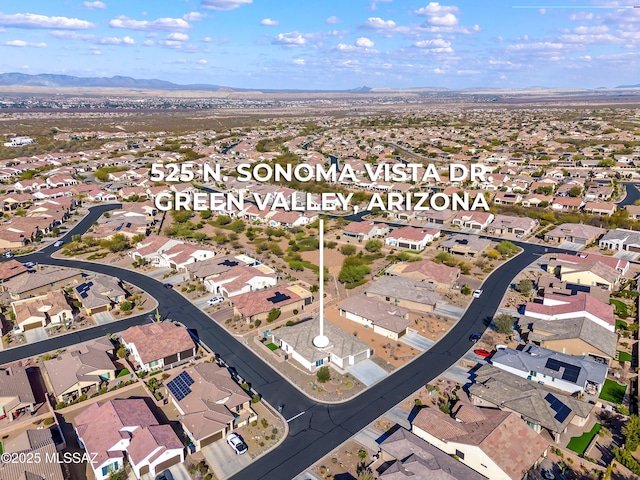 birds eye view of property with a mountain view and a residential view