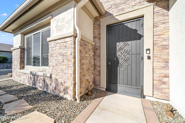 view of exterior entry with brick siding