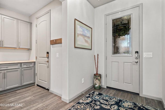 entryway featuring light wood-type flooring and baseboards