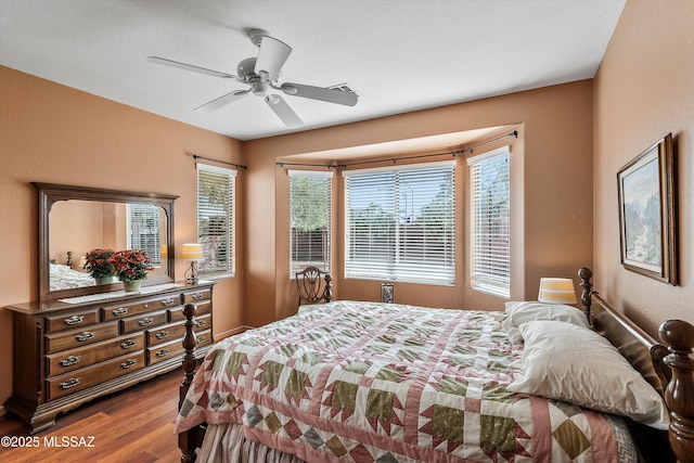 bedroom with a ceiling fan and wood finished floors