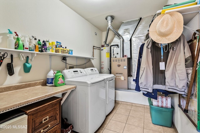 clothes washing area featuring laundry area, light tile patterned flooring, gas water heater, and independent washer and dryer